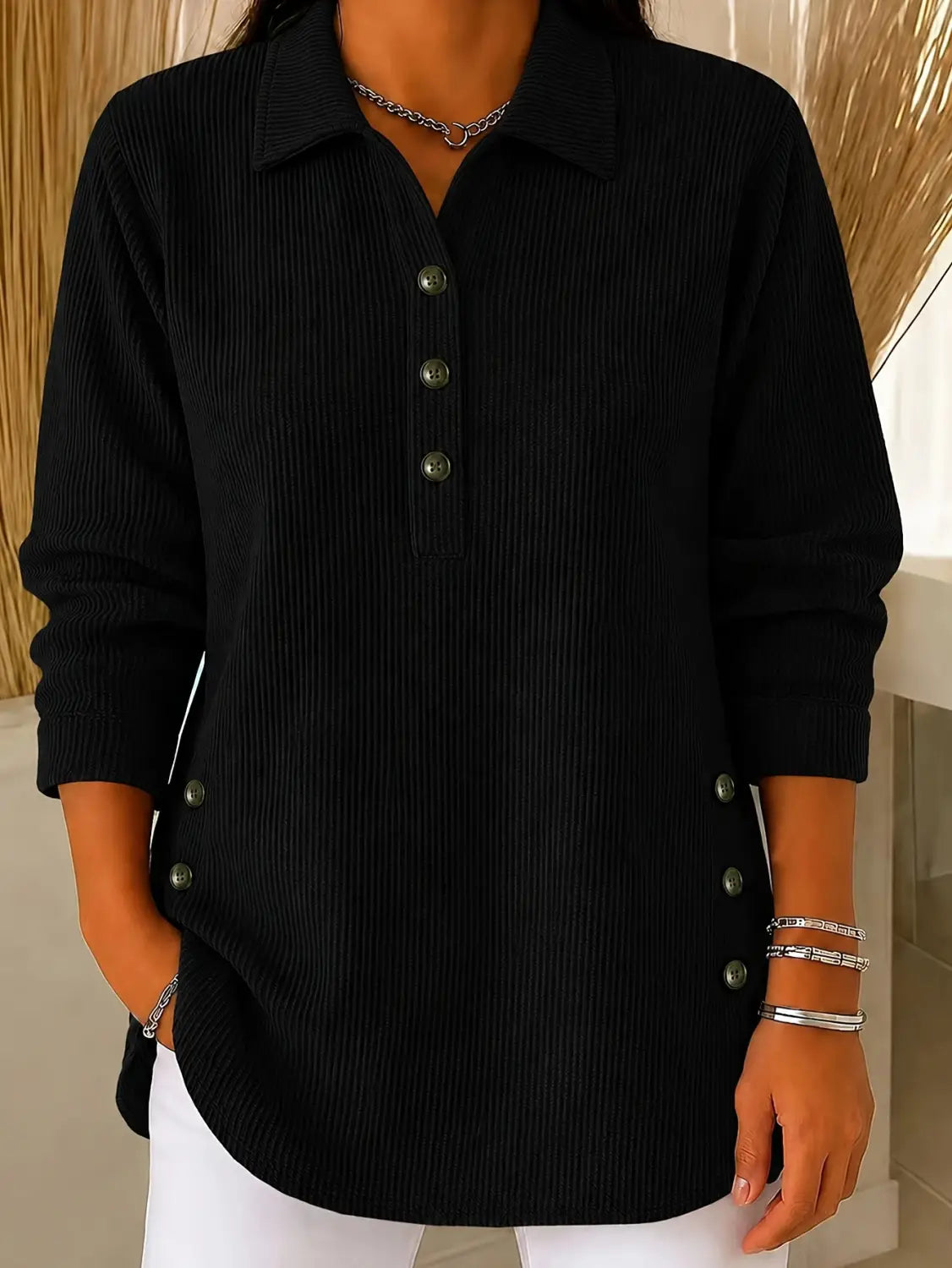 Black ribbed knit long-sleeve button-up sweatshirt with silver buttons and side pockets for casual wear.