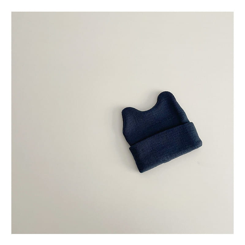 Navy blue knitted childrens beanie hat with folded cuff made of warm yarn for winter use.