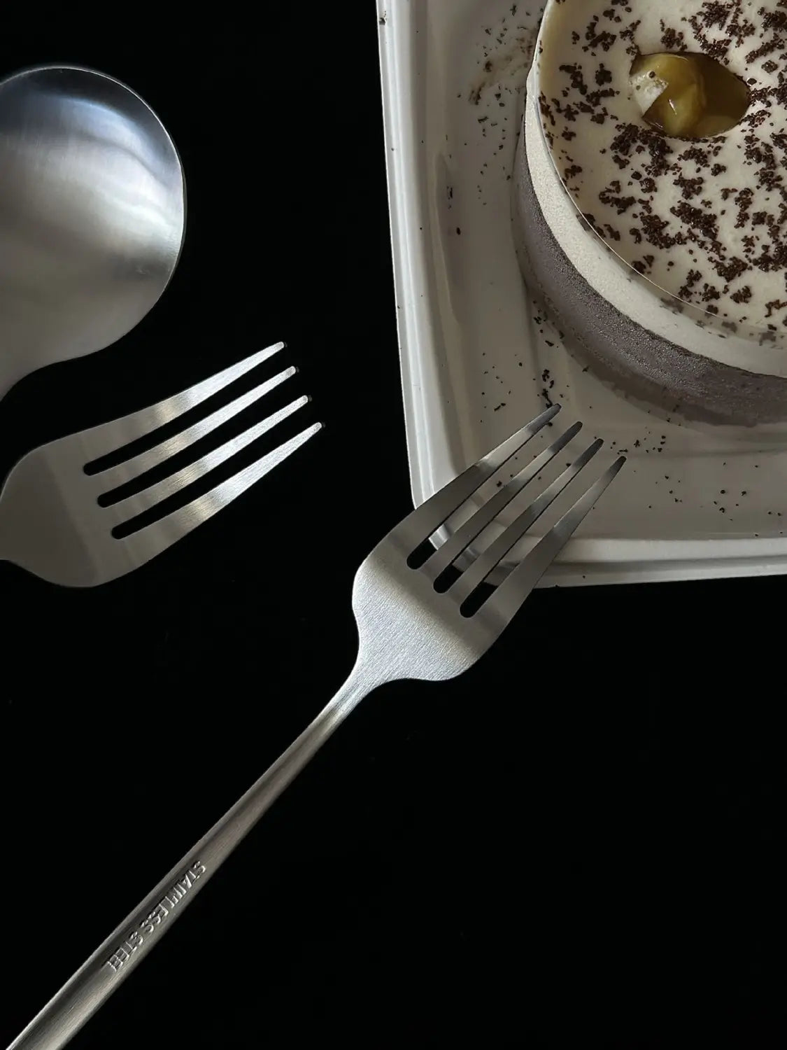 A sleek stainless steel fork from a stainless steel matte cutlery set featuring a modern design and engraved branding along the handle.