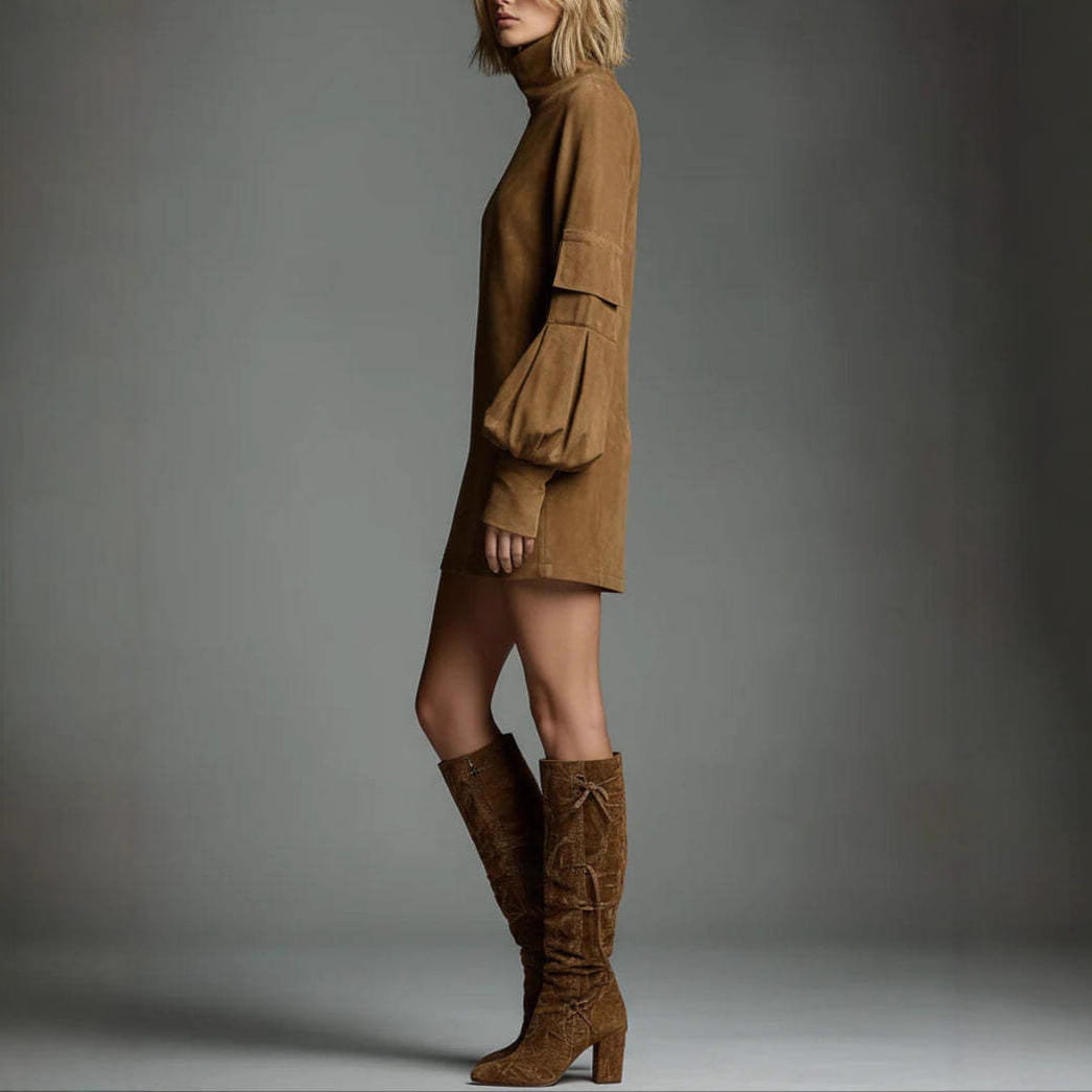 A tan suede mini dress with a high neckline and voluminous tiered long sleeves.