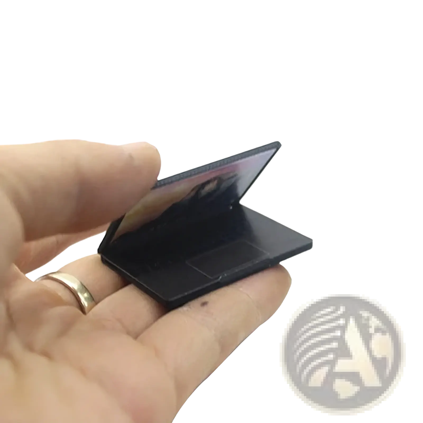 Black miniature laptop dollhouse accessory with sleek glossy finish in 1:12 scale compact design