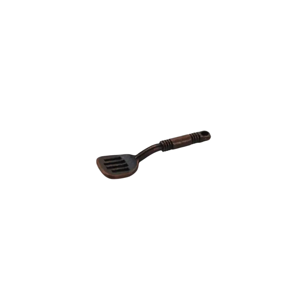 Dark brown miniature metal spatula with textured handle and slotted head from 1:12 miniature kitchen utensil set