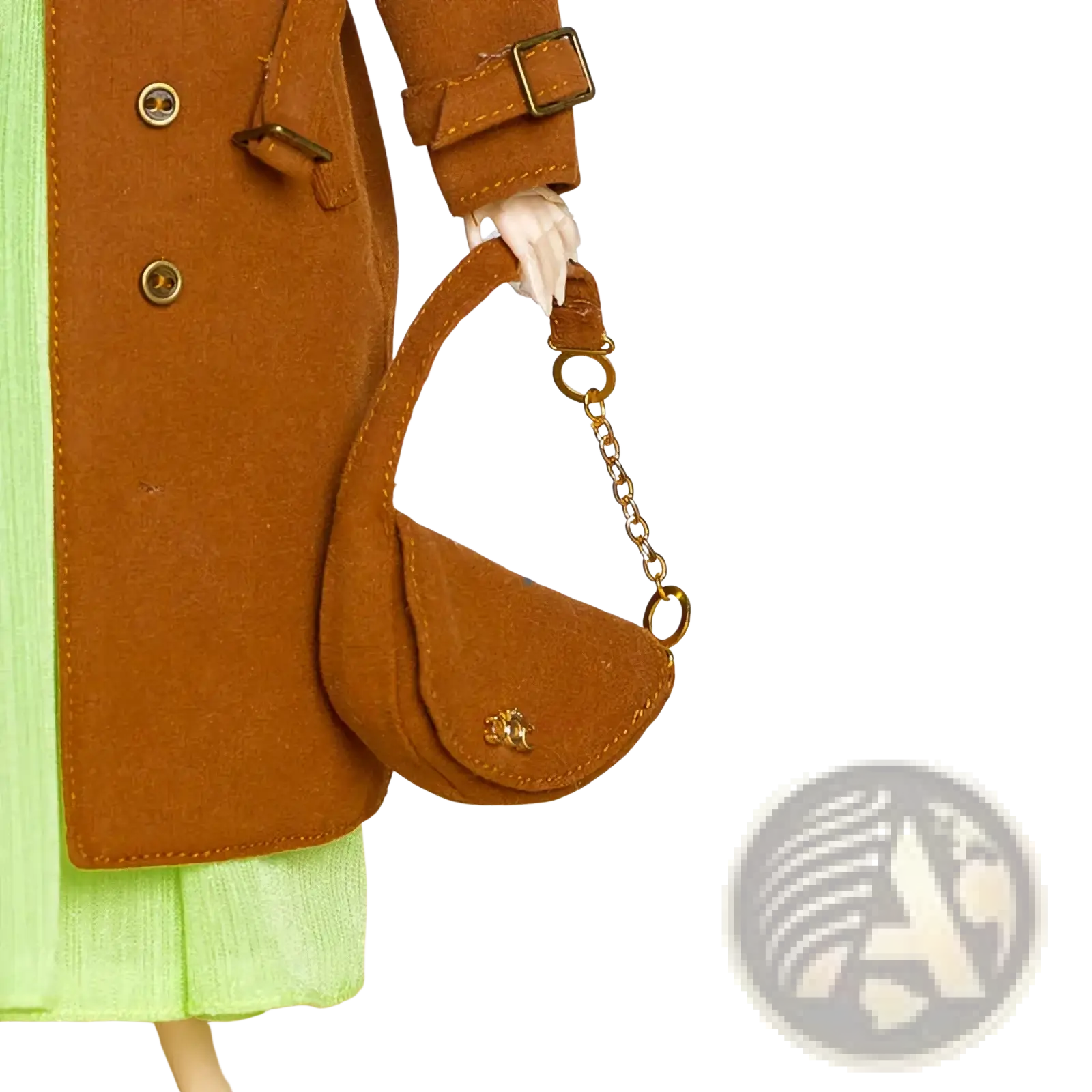 A tan suede 1/6 doll mini handbag with a gold chain strap and a small metallic logo on the front