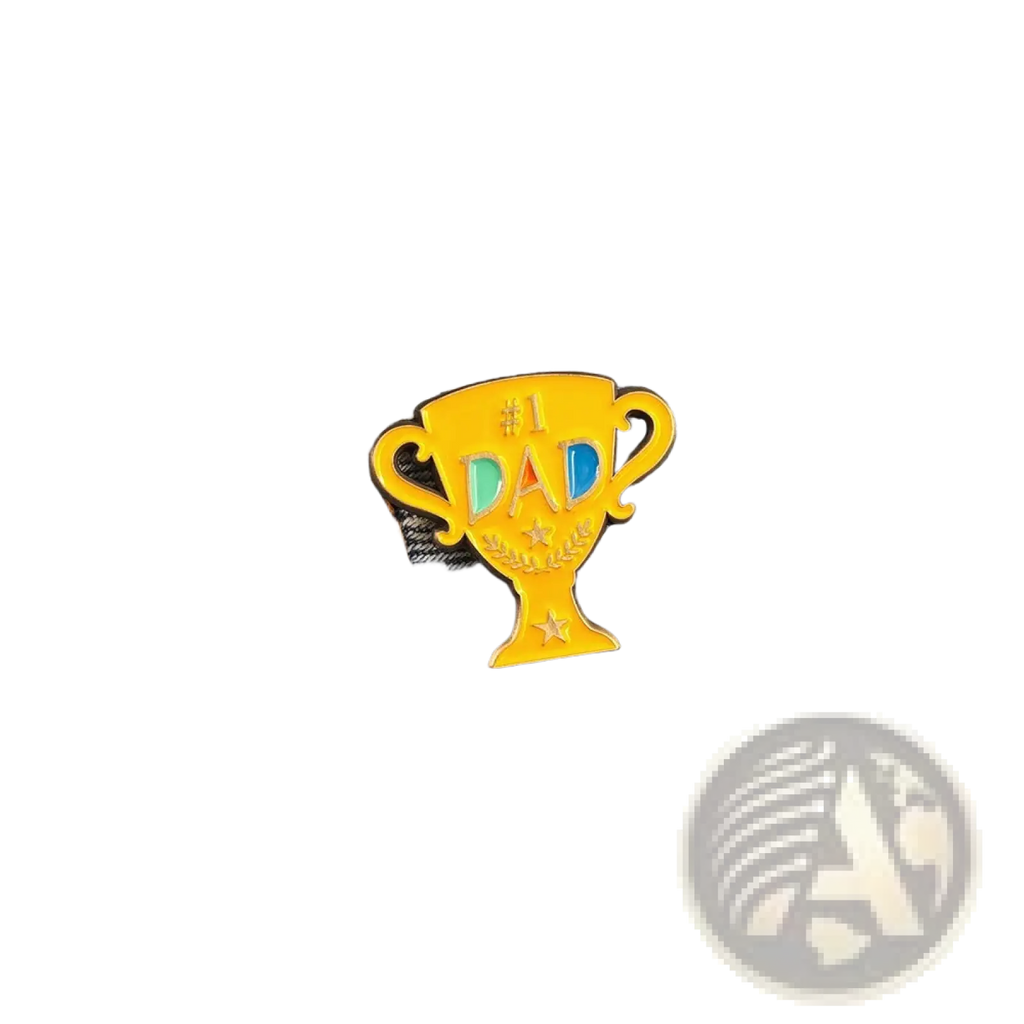 A shiny gold enamel #1 dad trophy pin with colorful letters and stars on denim fabric