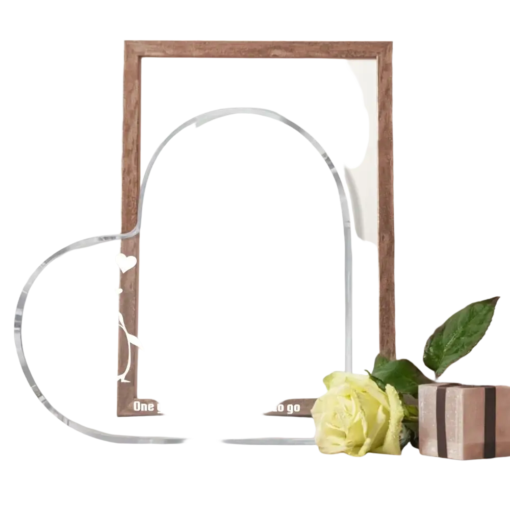 Clear acrylic heart-shaped 1 year anniversary plaque with engraved text and penguin design in white color