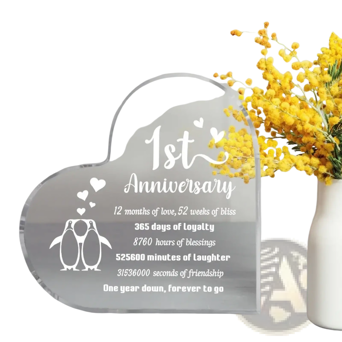Clear acrylic heart-shaped 1 year anniversary plaque with white engraved text and penguin design