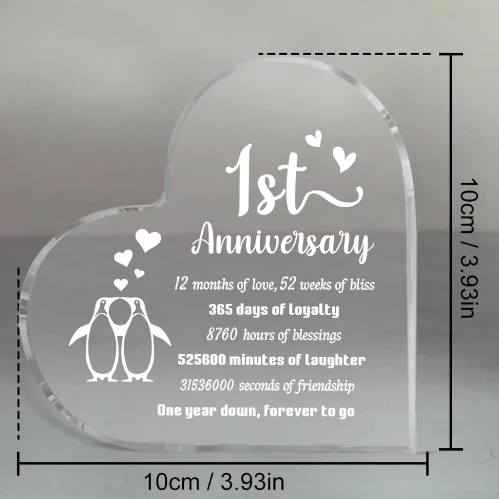 Clear heart-shaped acrylic plaque with engraved white text and penguin design for 1 year anniversary celebration