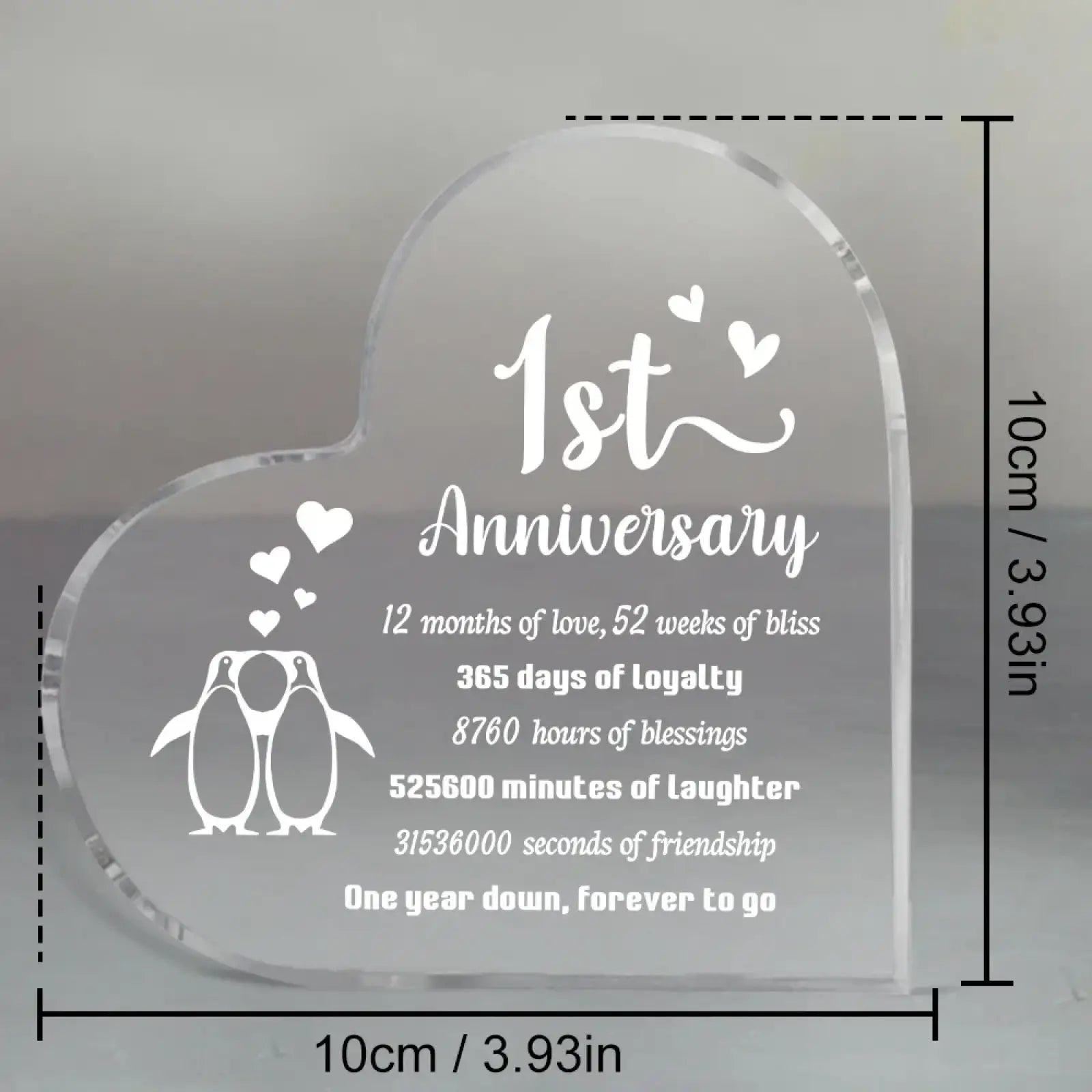 Clear heart-shaped acrylic plaque with engraved white text and penguin design for 1 year anniversary celebration