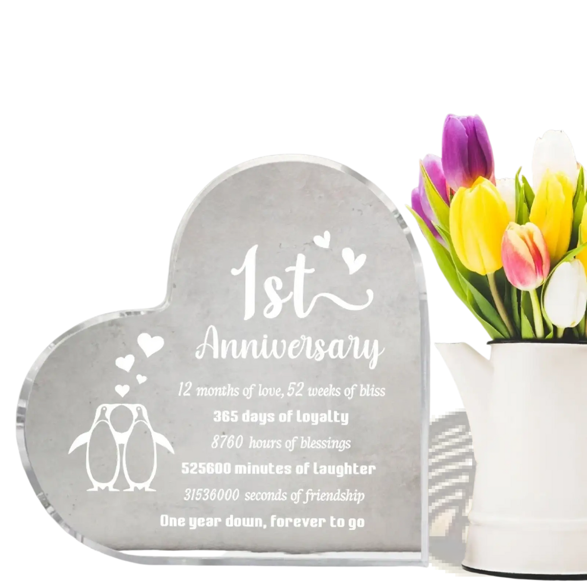 Clear acrylic heart-shaped 1 year anniversary plaque engraved with penguin illustrations and a sentimental love message