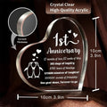 A heart-shaped crystal-clear acrylic 1 year anniversary plaque with a silver metallic rim and engraved text