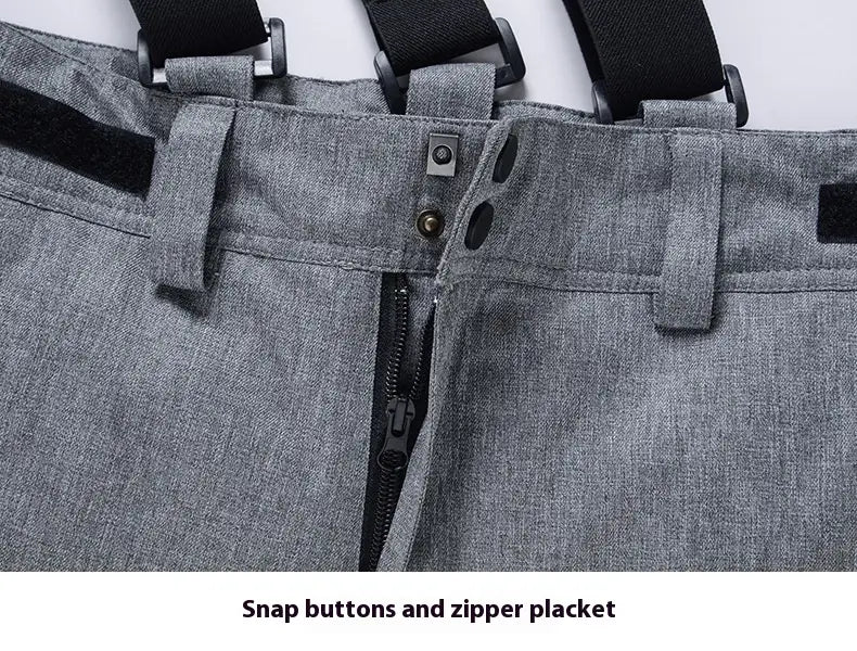 Men waterproof thermal snow pants in gray textured fabric with black adjustable straps and a zipper placket.