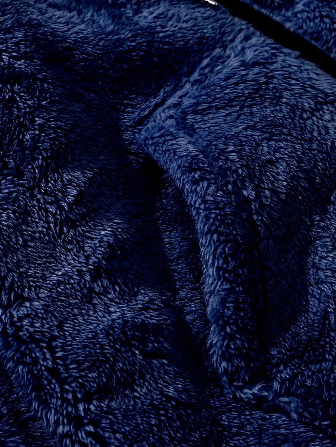Men’s fleece lined loose zip up hooded jacket in deep navy blue plush fleece fabric with a soft textured surface.