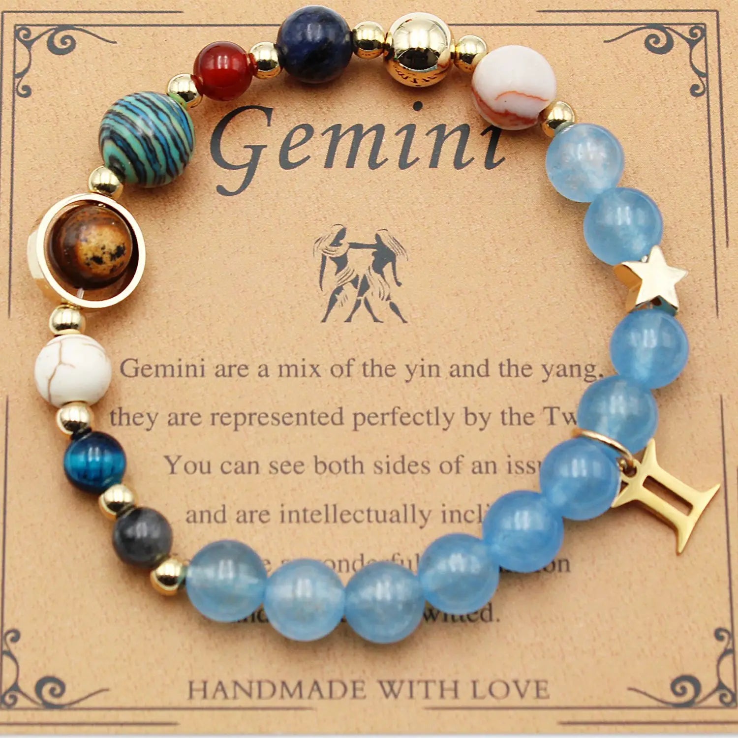 Natural stone twelve zodiac constellation beaded bracelet featuring a delicate gemini design with translucent blue and deep navy beads accented by gold-toned metallic spacers, a star charm, and an elegant golden taurus symbol.
