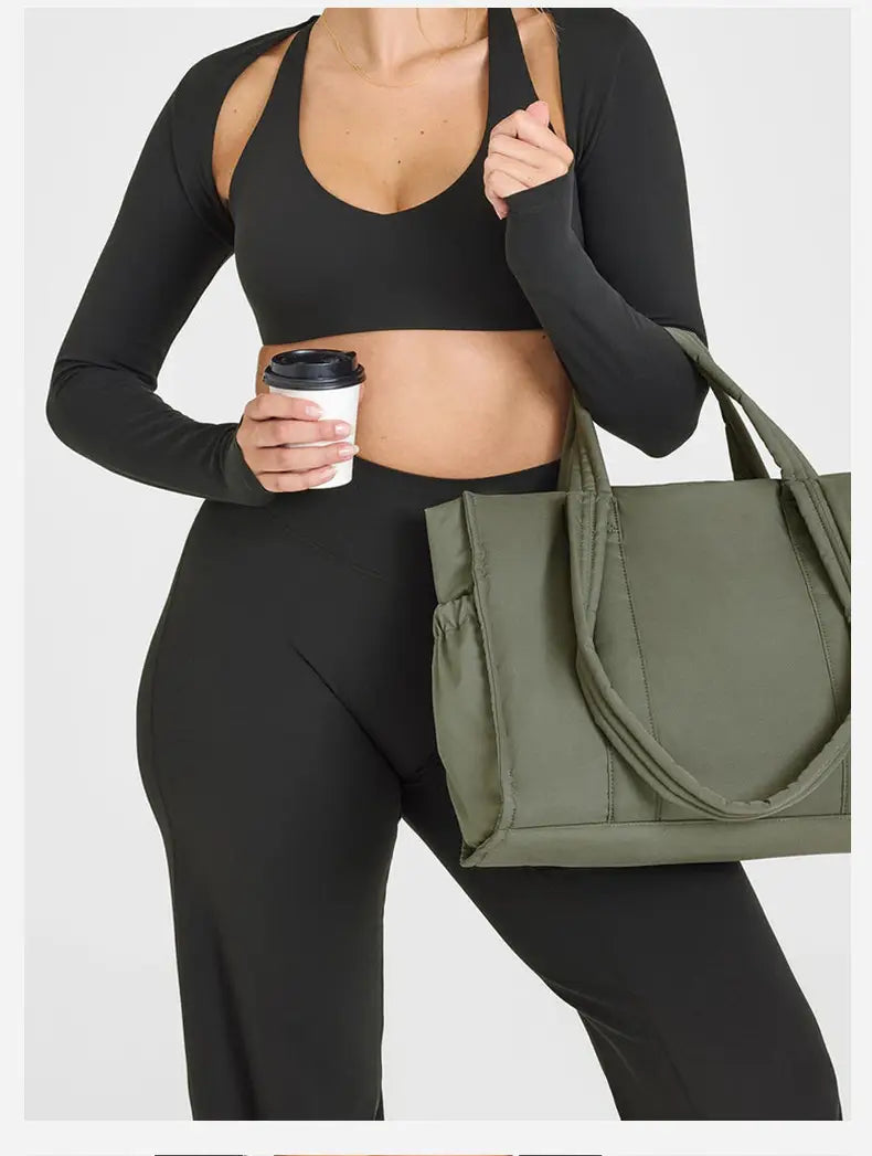 olive green canvas tote bag with reinforced handles and a side pocket shown alongside slimming yoga pants high waisted straight leg product.