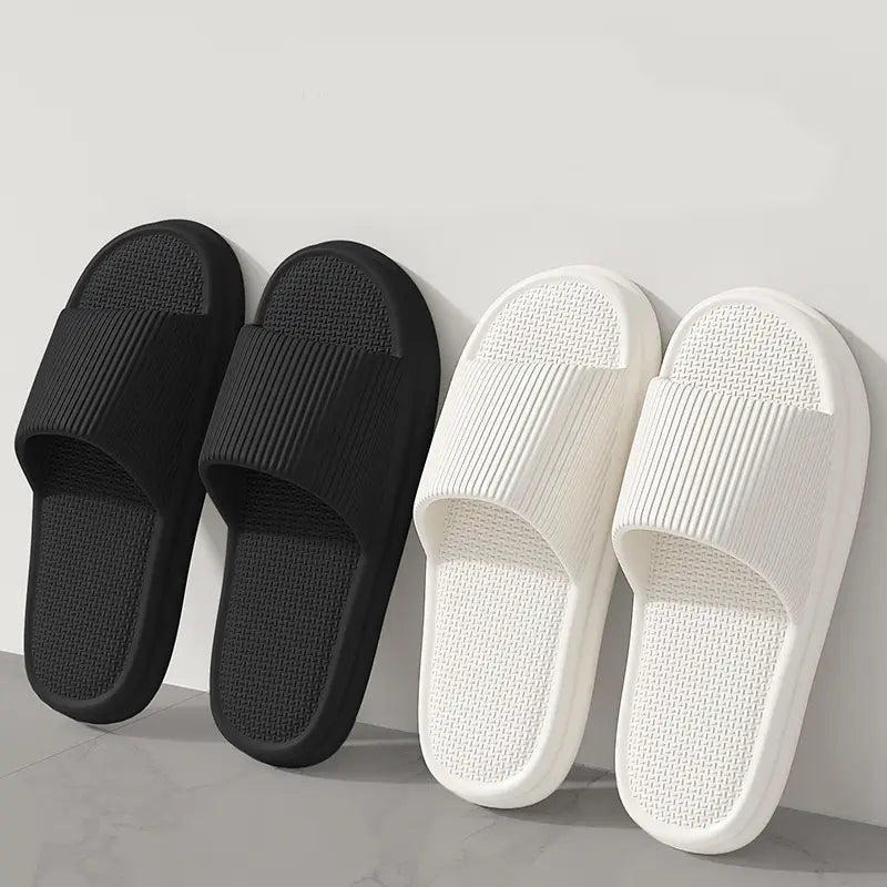 Unisex black and white ribbed rubber slide sandals with anti slip textured eva soles for house use.