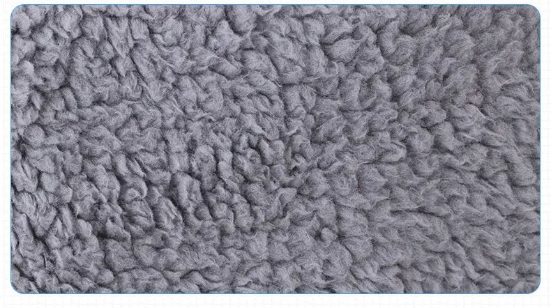 gray plush textured fabric of a pet grooming glove silicone hair remover bath brush with a soft fuzzy surface