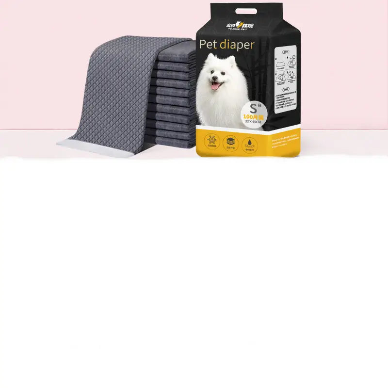 A stack of dark gray quilted thickening absorbent dog pee pads in a black and yellow package featuring an image of a white dog for pet training.