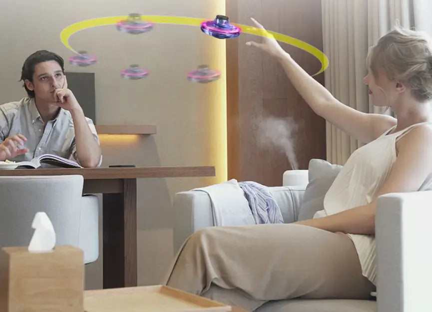 Purple and blue flying ufo spinner led mini drone with a circular design hovering as a fingertip gyro toy.