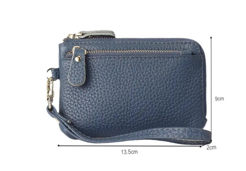 Navy blue textured leather wristlet wallet with silver-toned zipper and metal clasp featuring premium gold hardware.