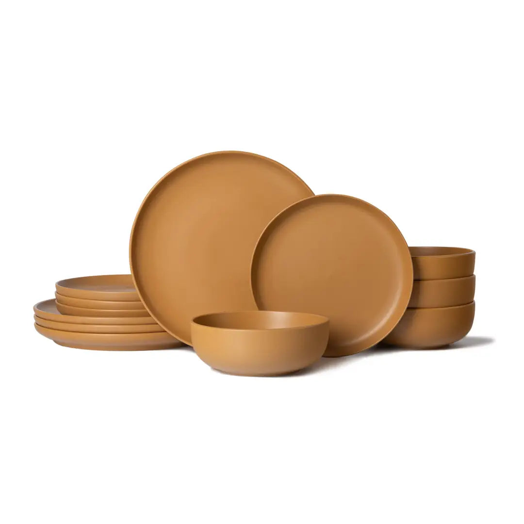 Tan ceramic stoneware dinnerware set with minimalist matte finish plates and bowls designed for four people in a 12 piece set.