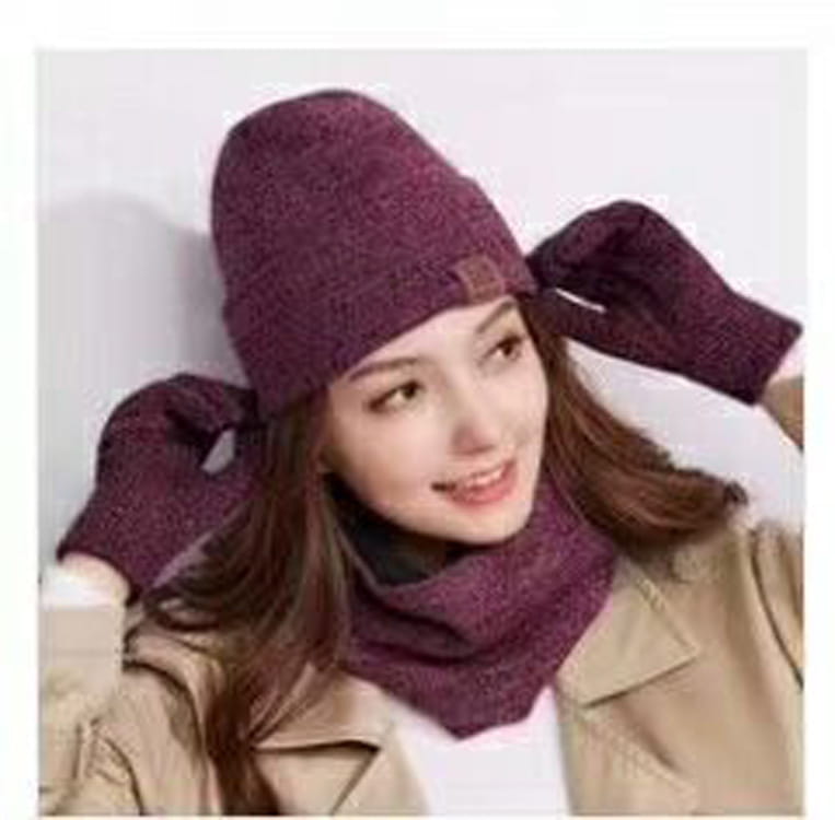 Purple knitted winter set featuring a beanie, scarf, and matching gloves designed for warmth and style.