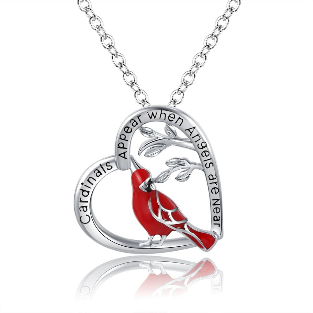 A silver heart-shaped pendant necklace featuring a red cardinal perched on branches with the inscription cardinals appear when angels are near.