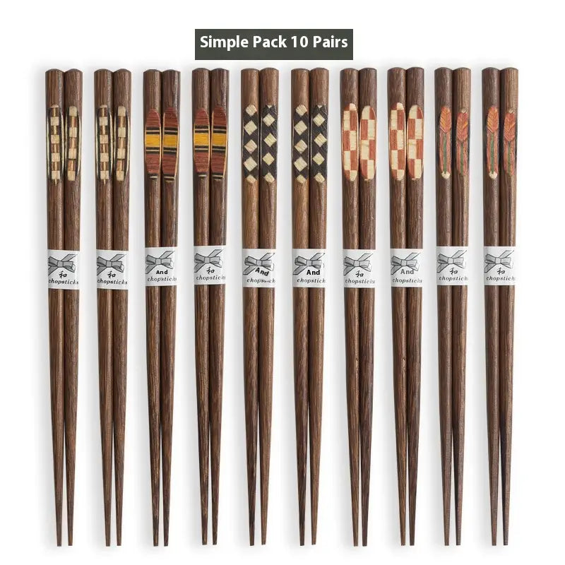 Set of ten pairs of dark brown wooden chopsticks with decorative inlaid patterns and non slip tips with white paper bands.