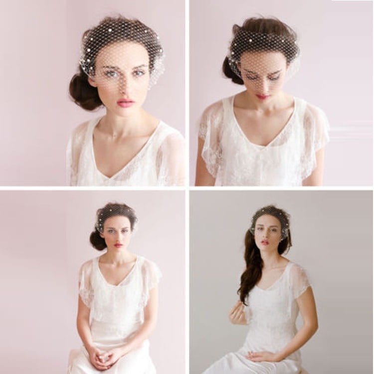 A delicate black mesh bridal veil adorned with small pearl beaded embellishments and secured with a gold hair comb worn elegantly over a styled updo.