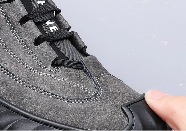Men’s suede casual sneaker in gray with black laces white stitching details and a chunky rubber sole.