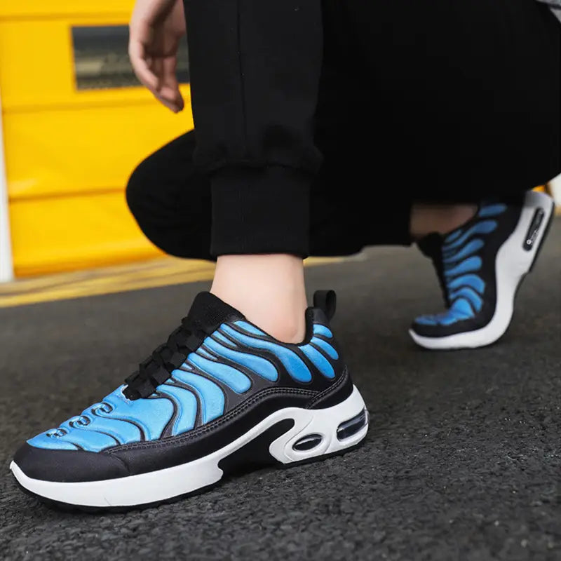 blue and black wave-patterned air cushion running shoes with a white air-cushioned sole designed for athletic use