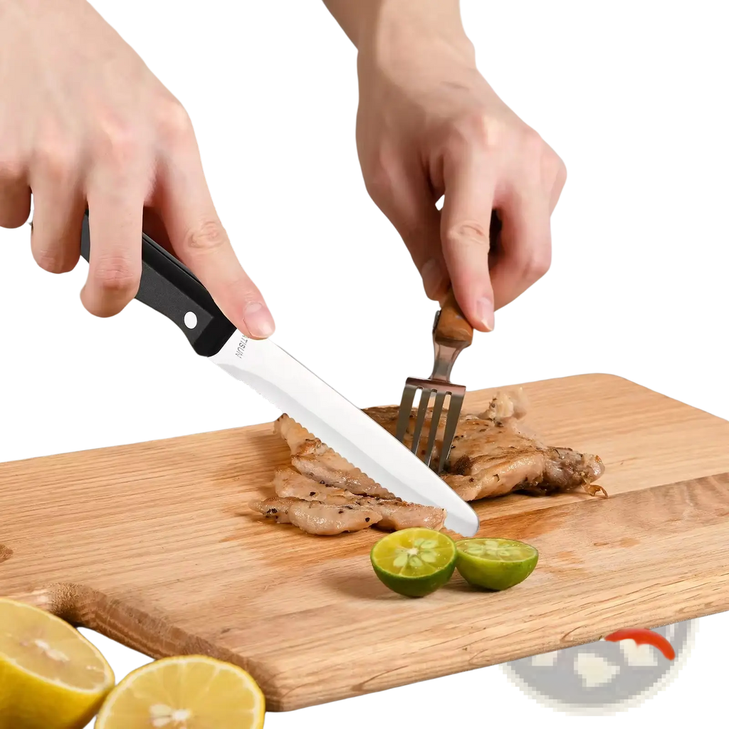 Black-handled serrated carbon steel steak knife slicing grilled meat on wooden board from 12 piece kitchen set with ABS handles