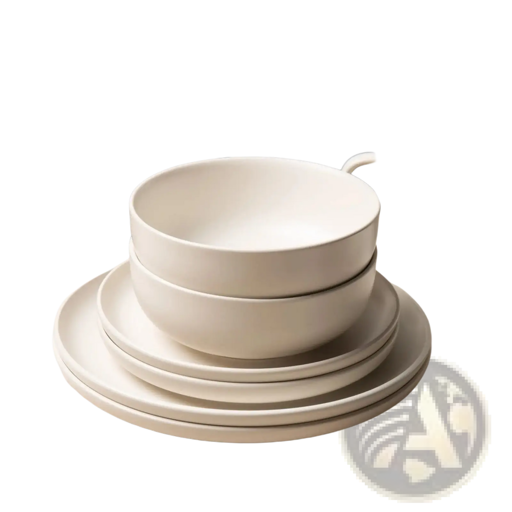Stack of minimalist white ceramic bowls with a smooth matte finish from a 12 piece stoneware dinnerware set with mugs