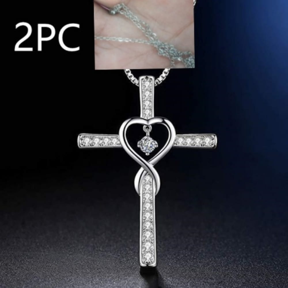 Silver cross pendant necklace with heart-shaped center, embedded clear crystals, and an infinity knot design from the Infinity Love Heart Cross Birthstone Crystal Necklace collection.