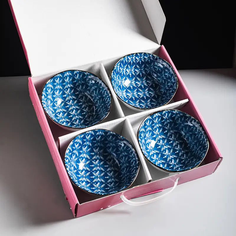 Set of four blue ceramic bowls with floral geometric pattern and gold metallic rim nestled in a pink gift box porcelain 5 inch.
