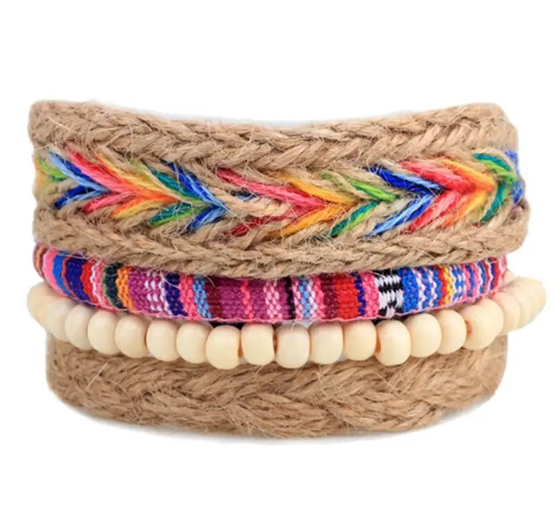Handmade multilayer braided leather and wood bead bracelet featuring a stack of three woven bracelets with a natural jute base, rainbow chevron embroidery, and bold multicolored geometric patterns.