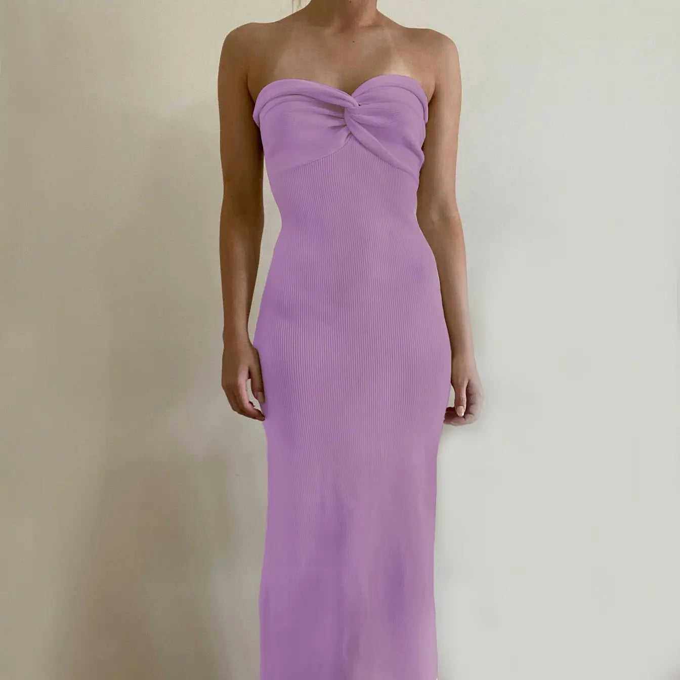 A strapless lavender ribbed knit maxi dress featuring a twisted bow at the bust in an off shoulder knotted ribbed knit midi dress style.