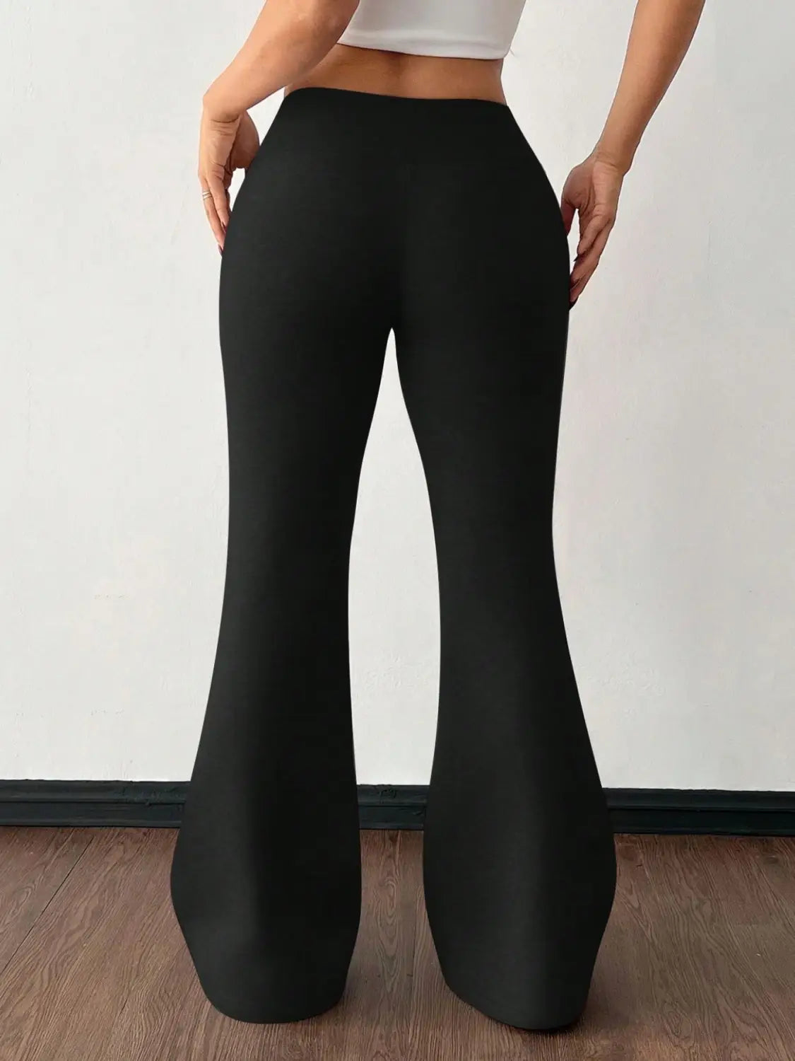 Black fleece lined high waist flared sweatpants made of smooth stretchy fabric for comfortable wear