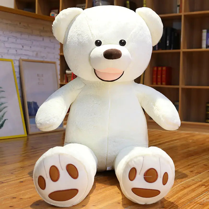 Ein großer weißer Teddybär-Plüschartikel mit braunen Pfotenabdrücken und einem lächelnden Gesicht, hergestellt aus weichem Samt und mit einer Größe von einem Meter.