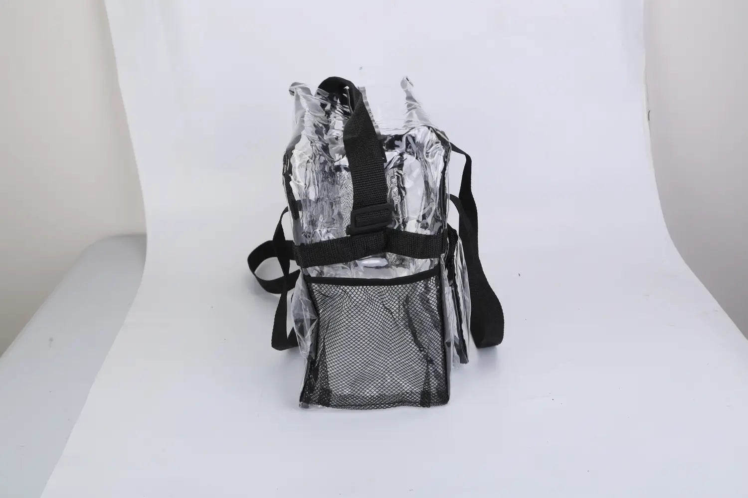 Stadium approved clear crossbody bag made of clear vinyl with black mesh panel and adjustable shoulder straps.