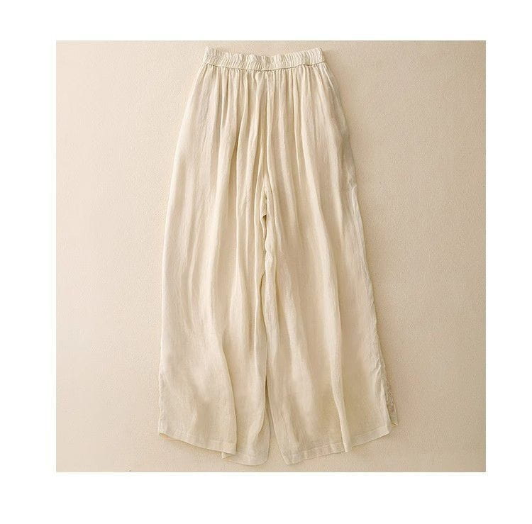 Cremefarbene bestickte Baumwoll-Leinen-Wide-Leg-Hosen mit lockerer Passform und elastischem Bund sowie einer entspannten, fließenden Silhouette.