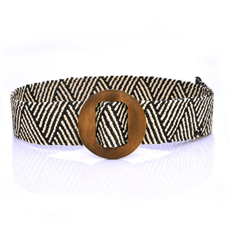 Woven elastic belt with black and white herringbone pattern and bronze-toned circular buckle.