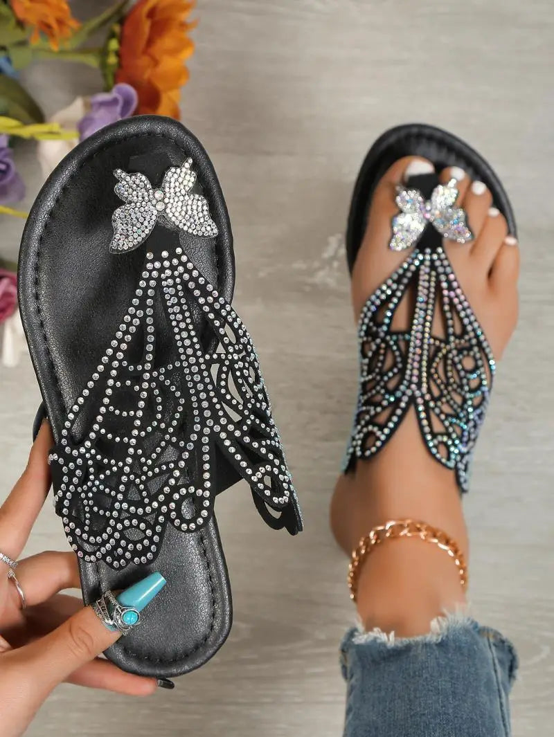 Women’s gold rhinestone hollow flat slip on sandals featuring butterfly embellishments and intricate cutout patterns.