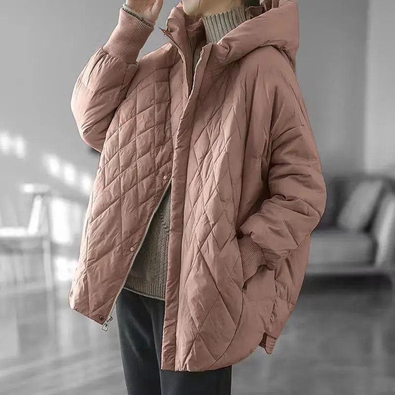 A soft rose-colored white duck down puffer jacket with quilting, a hood, and ribbed cuffs designed as a loose hooded winter coat.