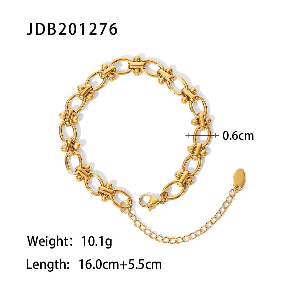 Gold plated stainless steel zirconia gemstone bangle bracelet with a gold-toned stainless steel chain featuring a sleek interlocking oval link design and an adjustable extension chain.