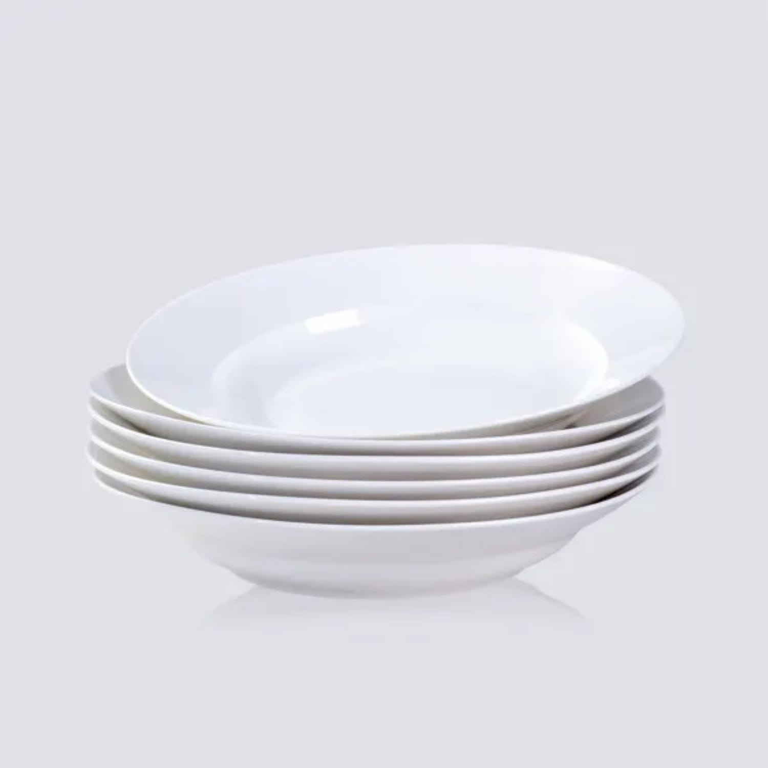 Stack of six white ceramic 9.5 inch soup bowls with smooth glossy finish and slightly flared rims for dinner use