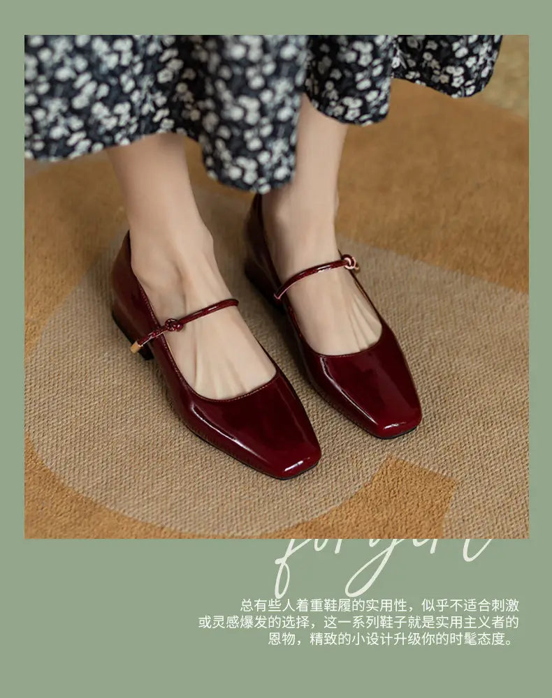 Square toe mary jane patent leather block heels in burgundy featuring a thin ankle strap with a gold tone buckle.
