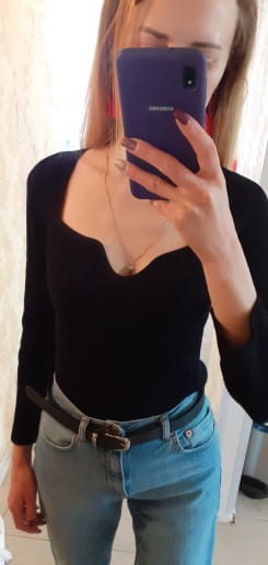 Black ribbed knit pullover with a sweetheart neckline and long sleeves designed for stylish layering.
