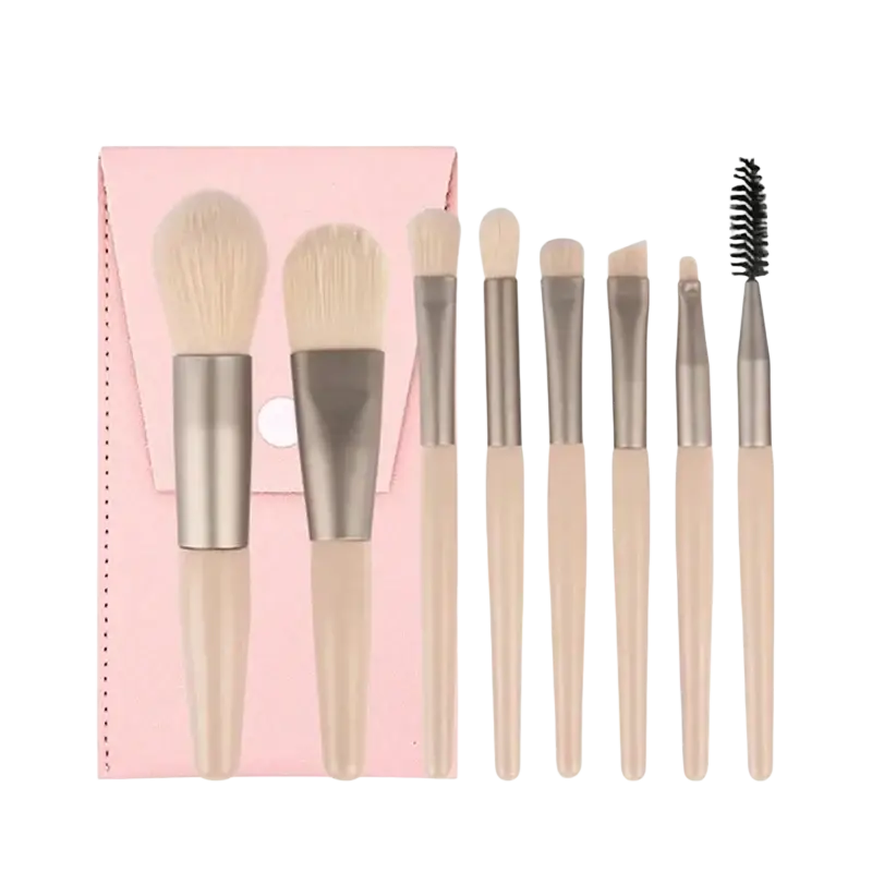 Set of seven beige handled makeup brushes with silver ferrules and soft bristles beside pink carrying case pouch