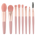 Set of seven rose gold and blush pink soft bristle makeup brushes from a 13-piece professional set with pouch