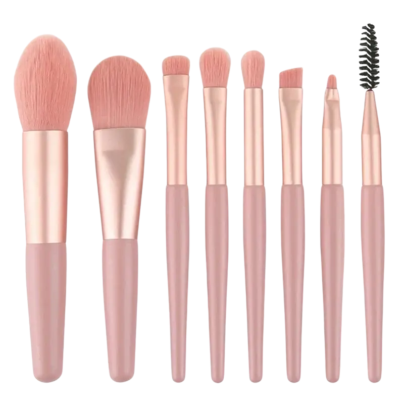 Set of seven rose gold and blush pink soft bristle makeup brushes from a 13-piece professional set with pouch